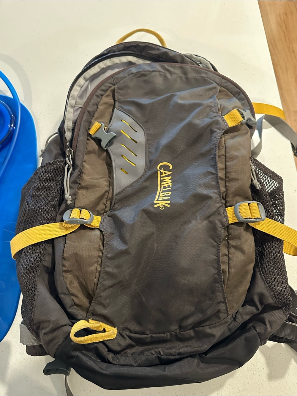 CamelBak Black Backpack with Yellow Accents and Blue Hydration Bladder